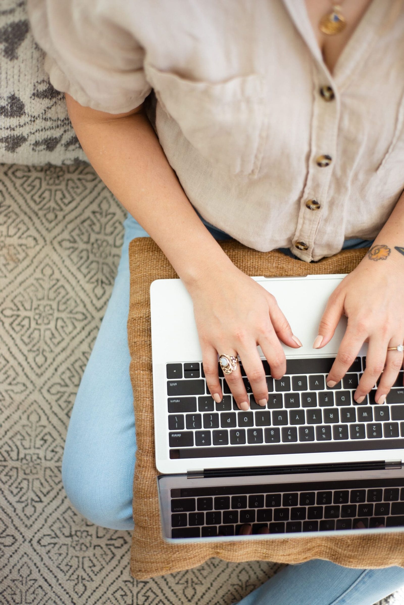 An online practitioner on a laptop from a comfortable location, reflecting the flexibility created when you know how to generate cash flow in your online practice.