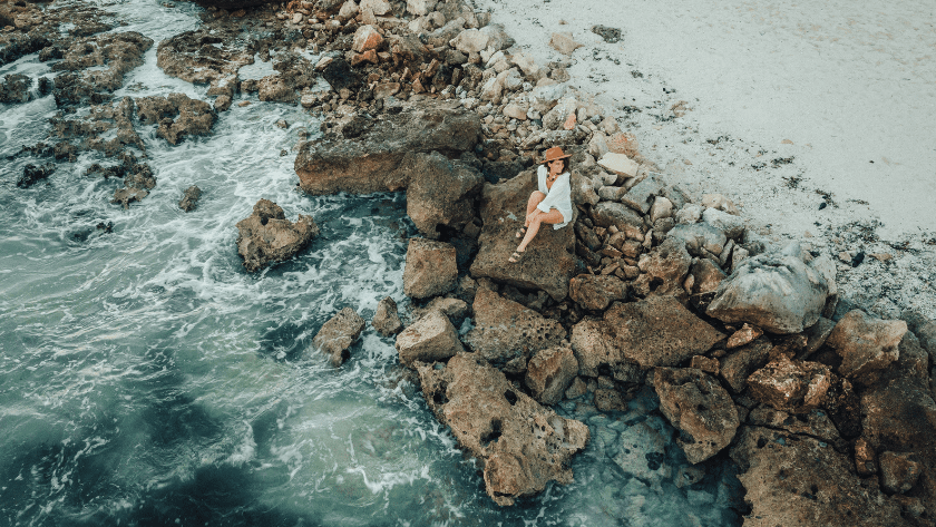 Health practitioner reflecting by the ocean on how to attract high-paying clients