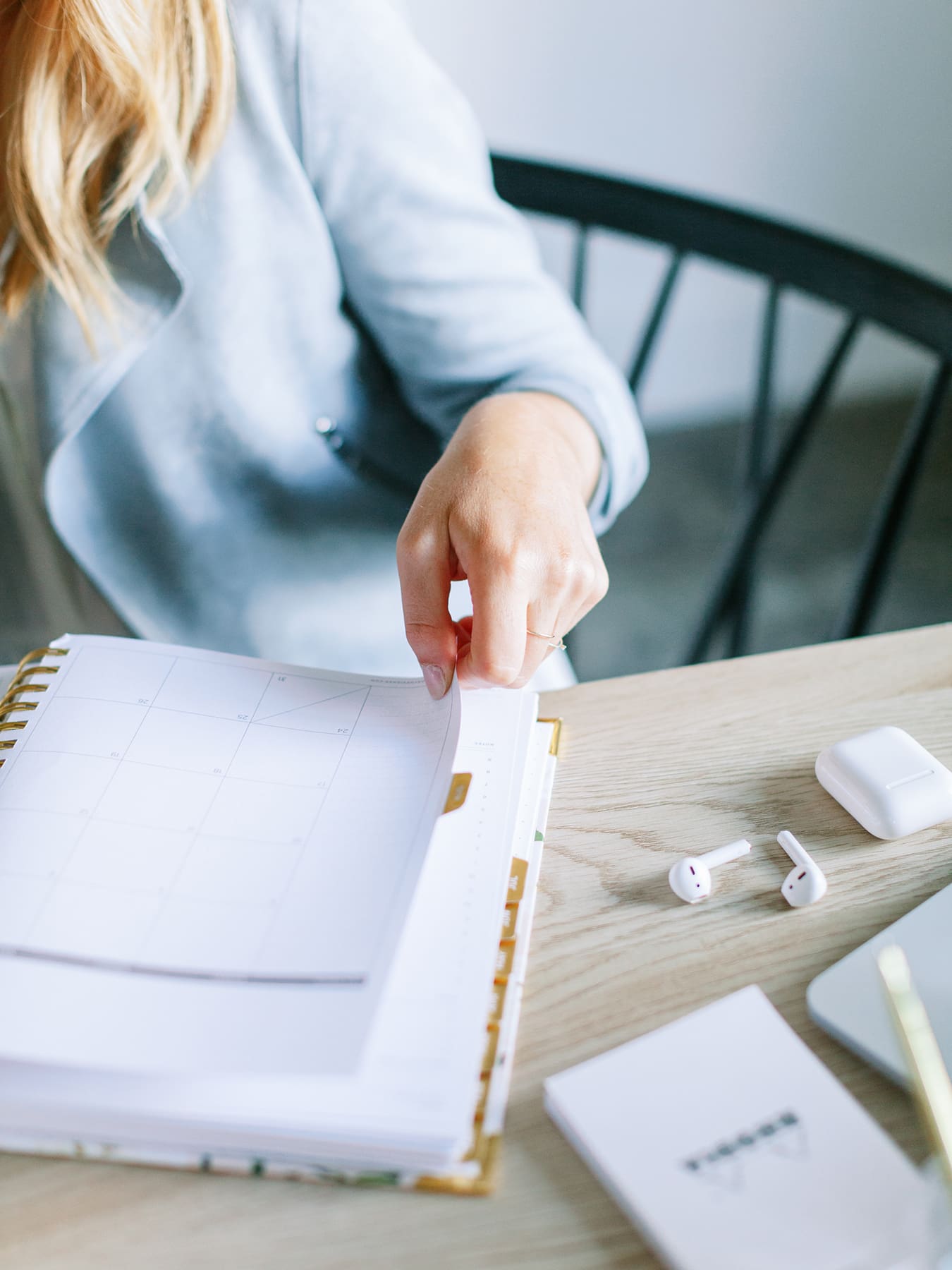 a health practitioner with her planner at a desk mapping out a plan for how to move your private practice online
