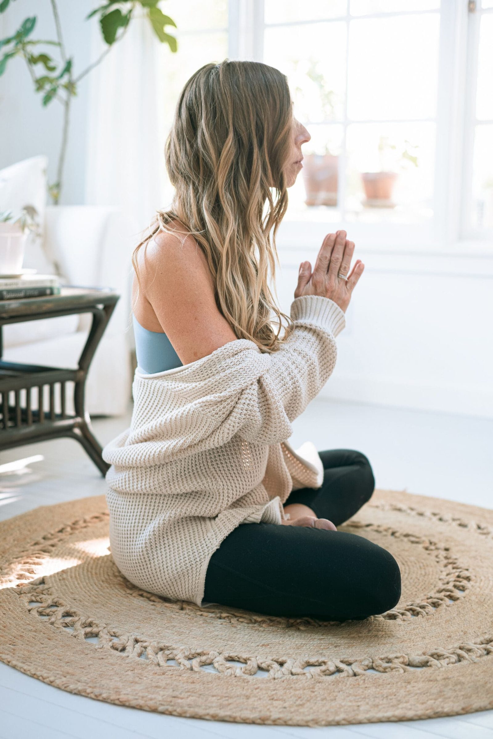 an online health practitioner doing yoga as part of her self-care practice for healthy client boundaries for health practitioners