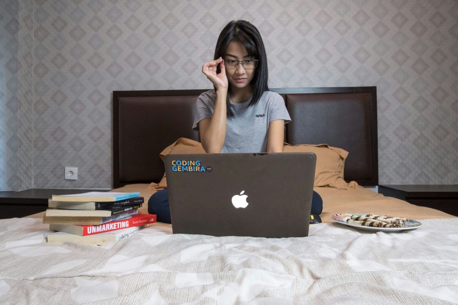 Professional woman using a laptop to design online wellness programs that help clients achieve lasting results.