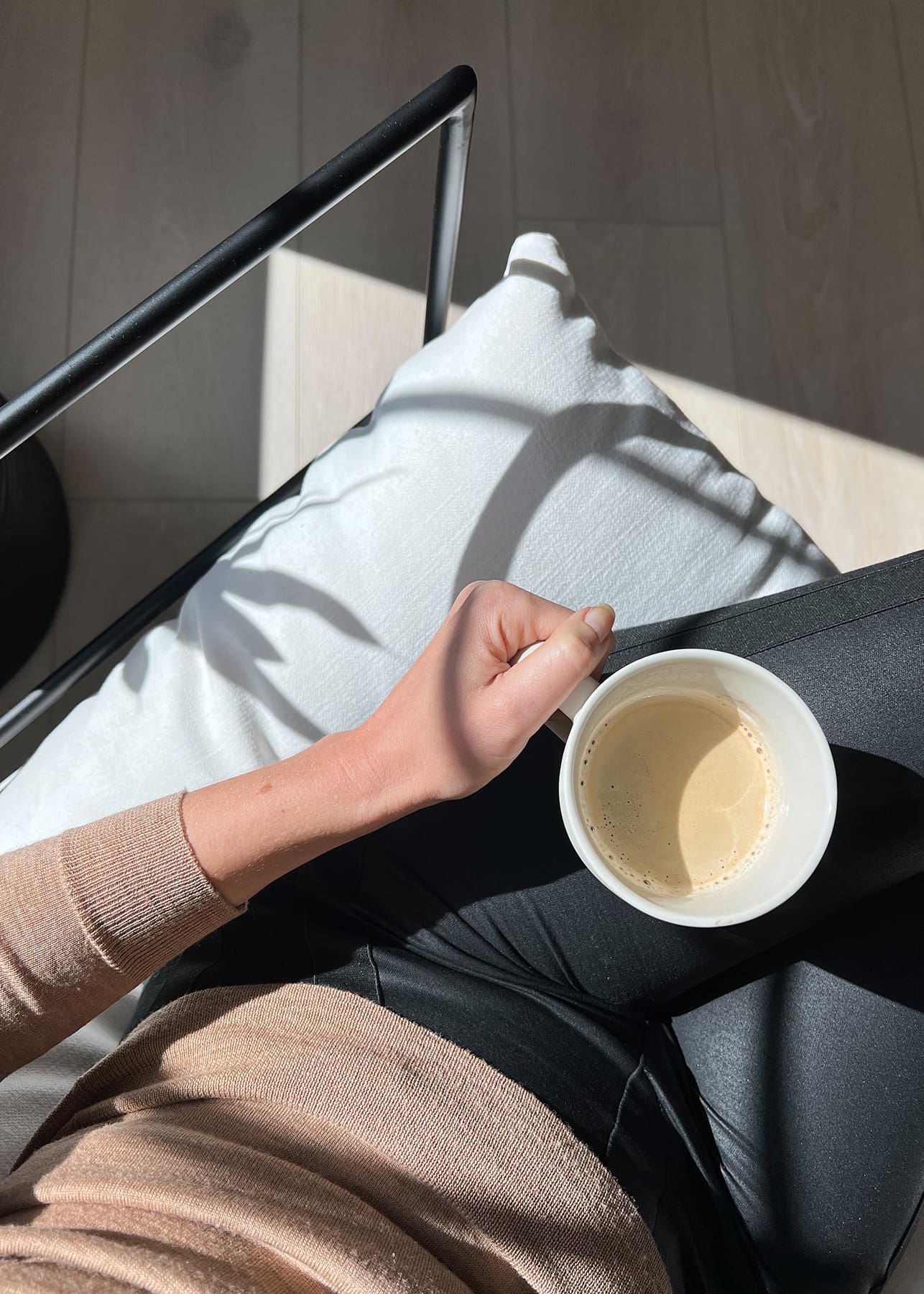 A practitioner relaxing with a warm drink, reflecting the improved work-life balance created through functional medicine for physical therapists.