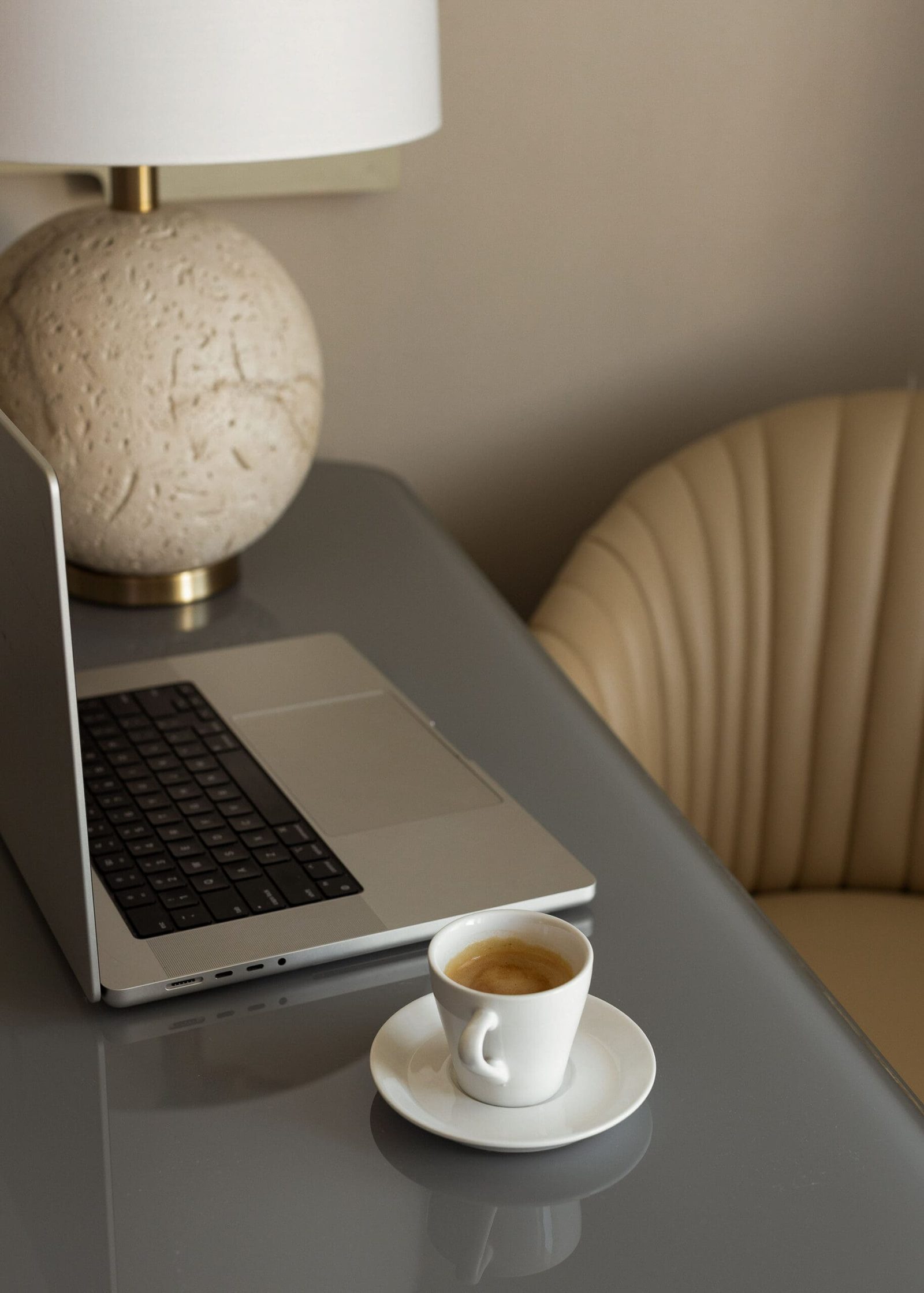 a laptop and coffee setup on a desk for an online health practitioner to learn how to improve your marketing message
