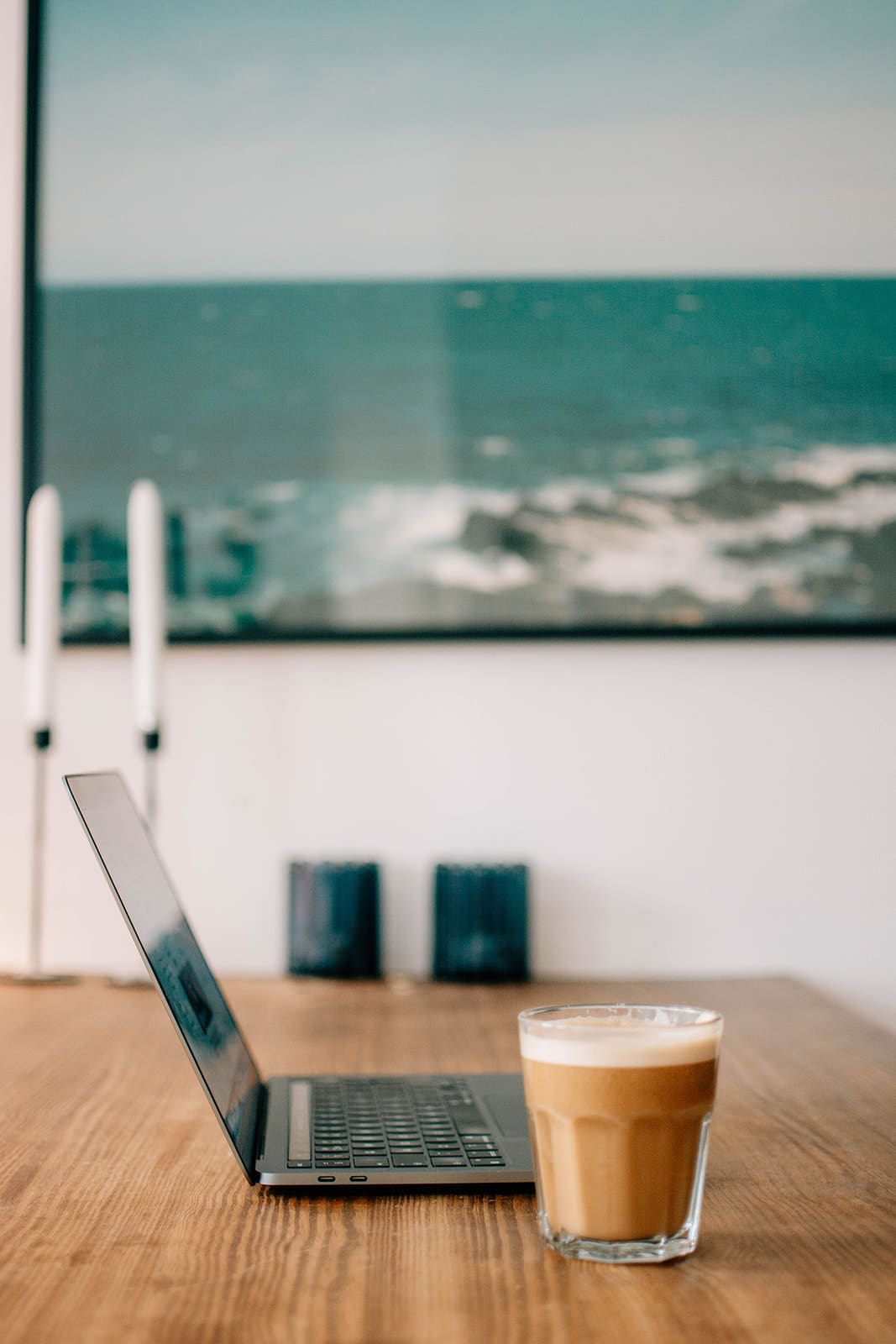 a laptop and coffee setup on a desk for an online health practitioner to learn how to sell without being salesy