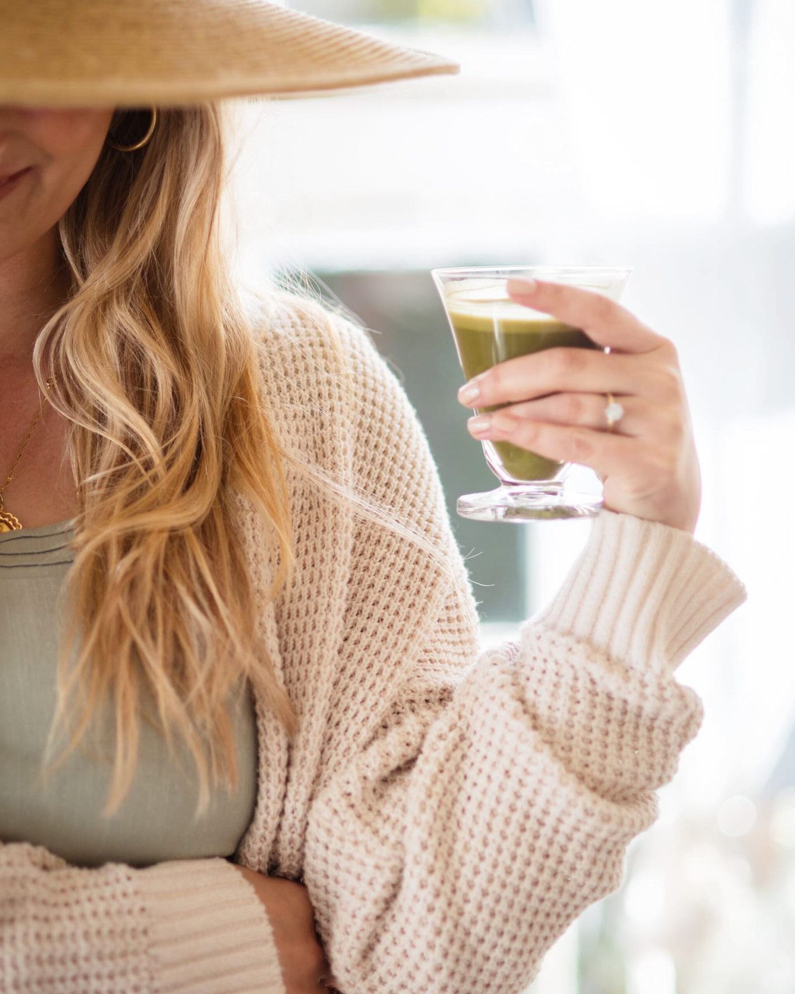 a medical doctor relaxing and drinking a green juice after learning how to transition from conventional medicine to functional medicine