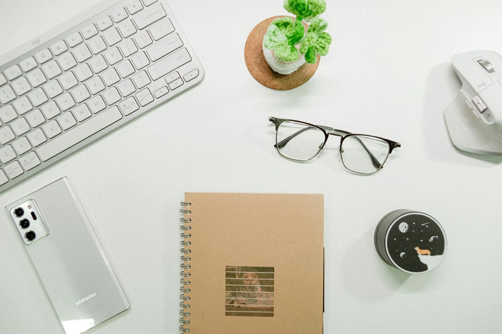 Workspace with notebook and glasses, representing clarity and focus in health practitioners’ content creation.