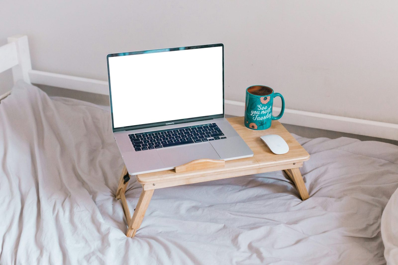 Naturopath reviewing client programs on laptop