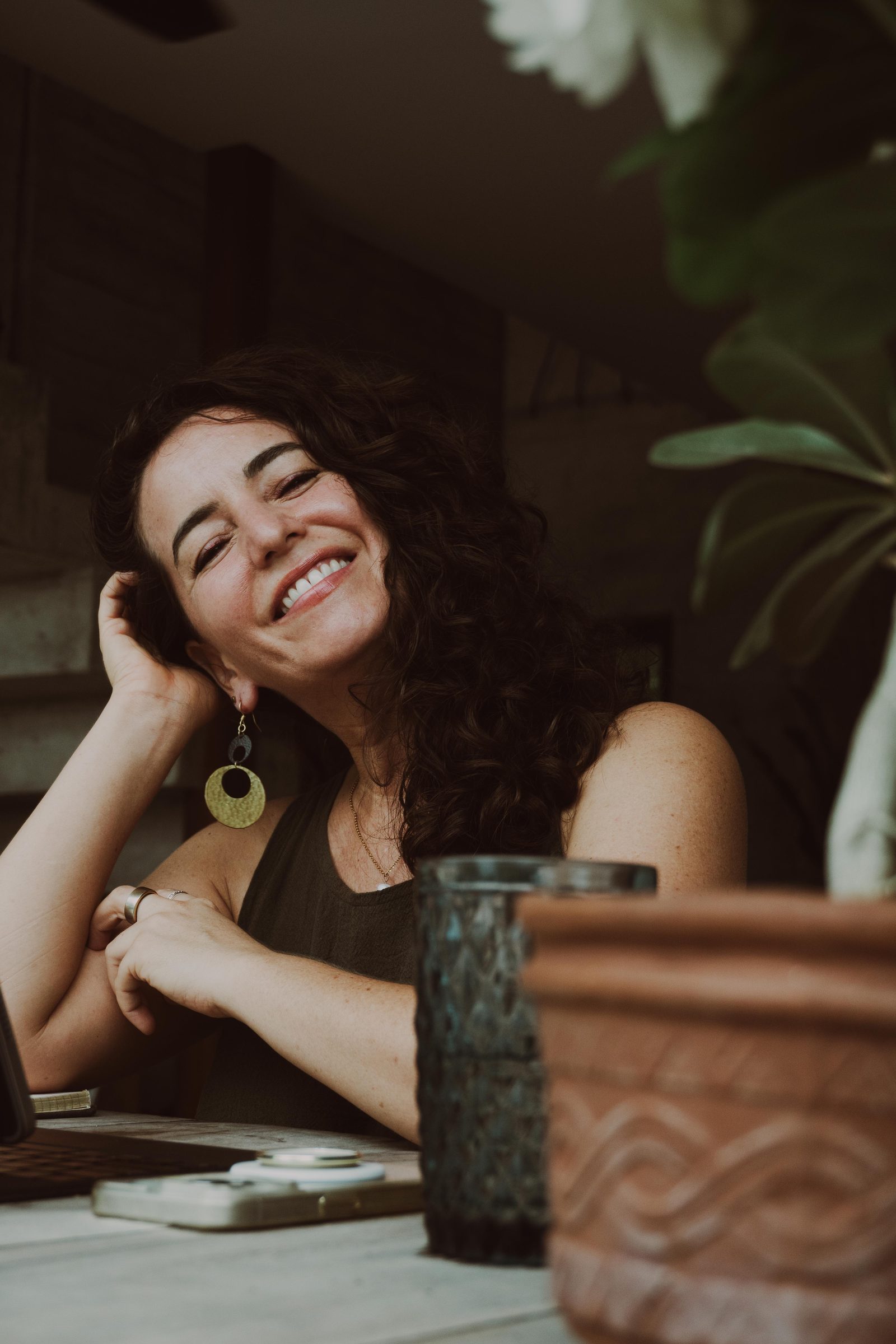 Michelle, smiling, seated at a table