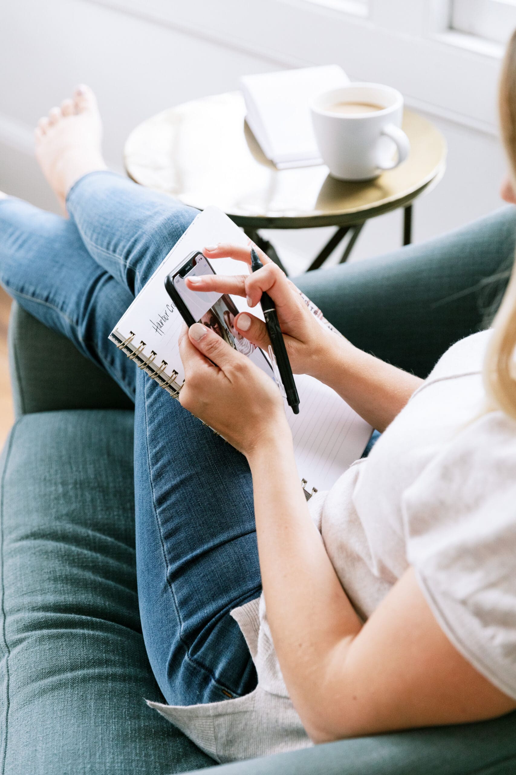woman sitting on the couch researching on her phone how to grow an online health practice