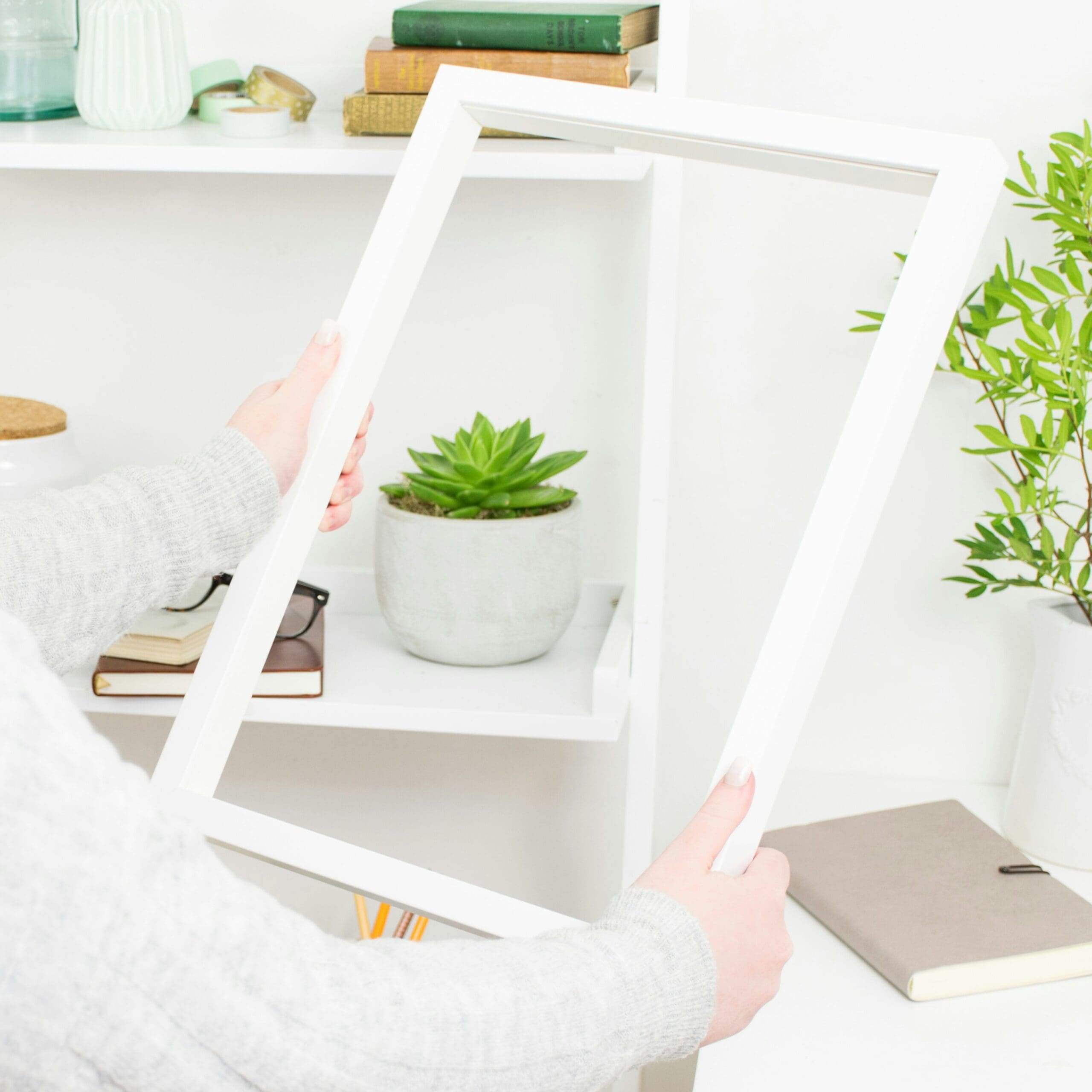 Health practitioner setting up a home office workspace with greenery and books for an online practice