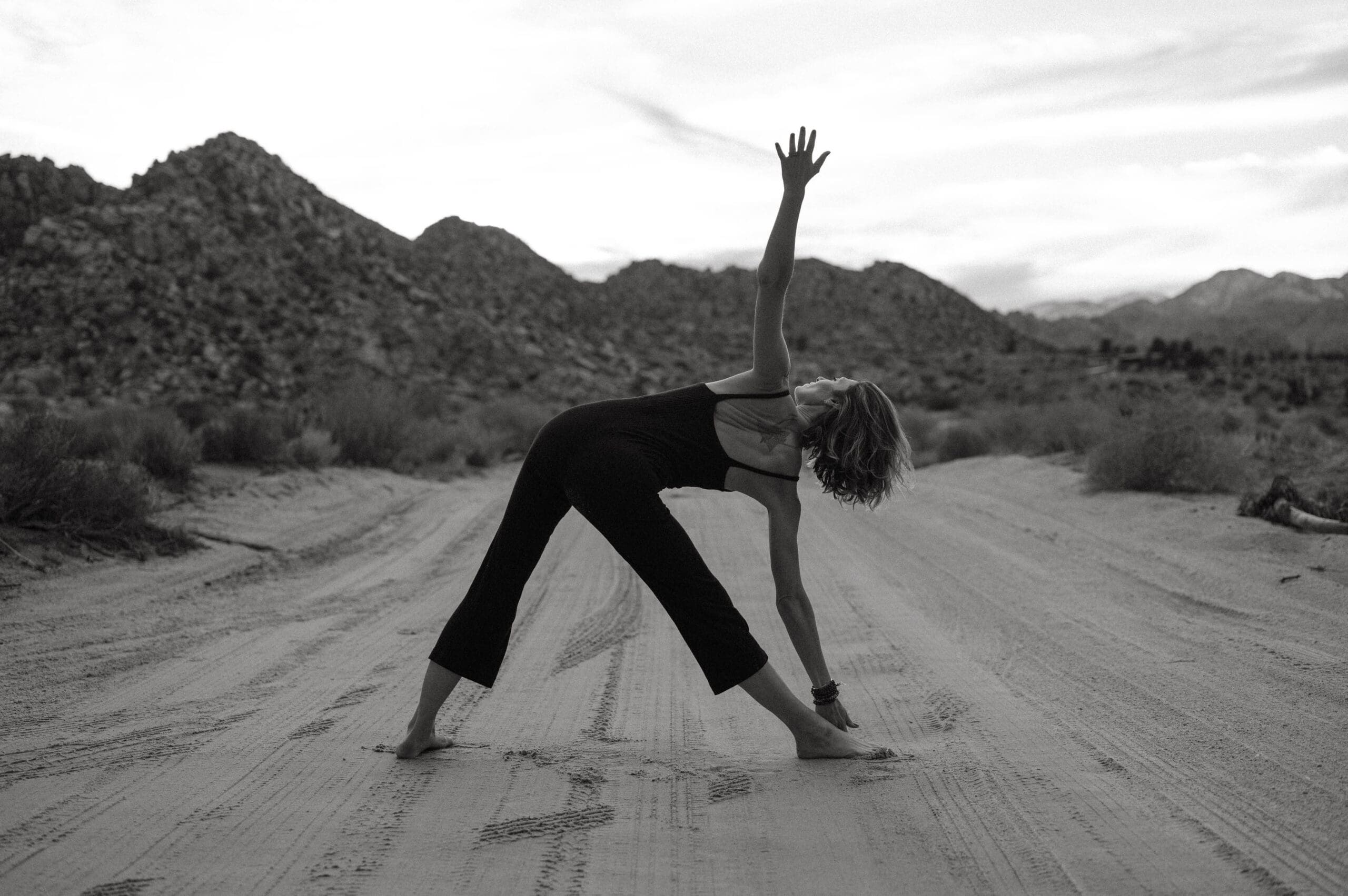 A woman doing yoga outside in the desert after she learned how to leave insurance as a healthcare practitioner